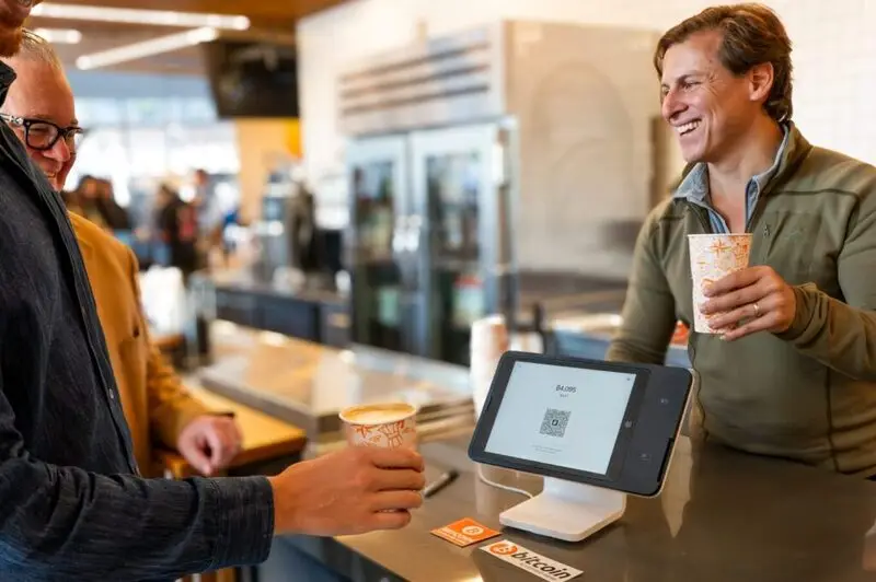 Square Terminal displaying Bitcoin payment QR code at Compass Coffee counter