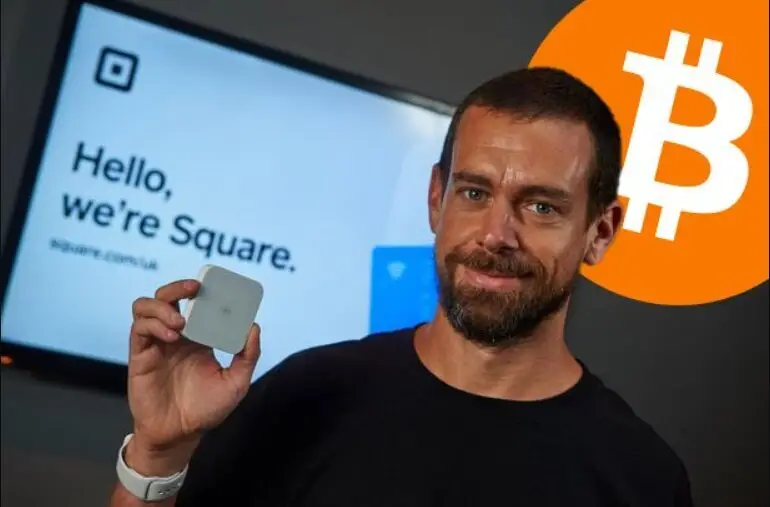 Jack Dorsey holding Square device with Bitcoin logo and "Hello, we're Square" branding