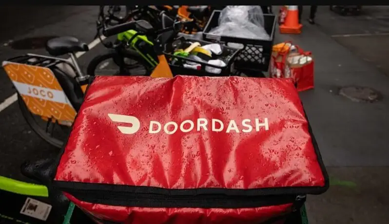 doordash food delivery rider with company bag
